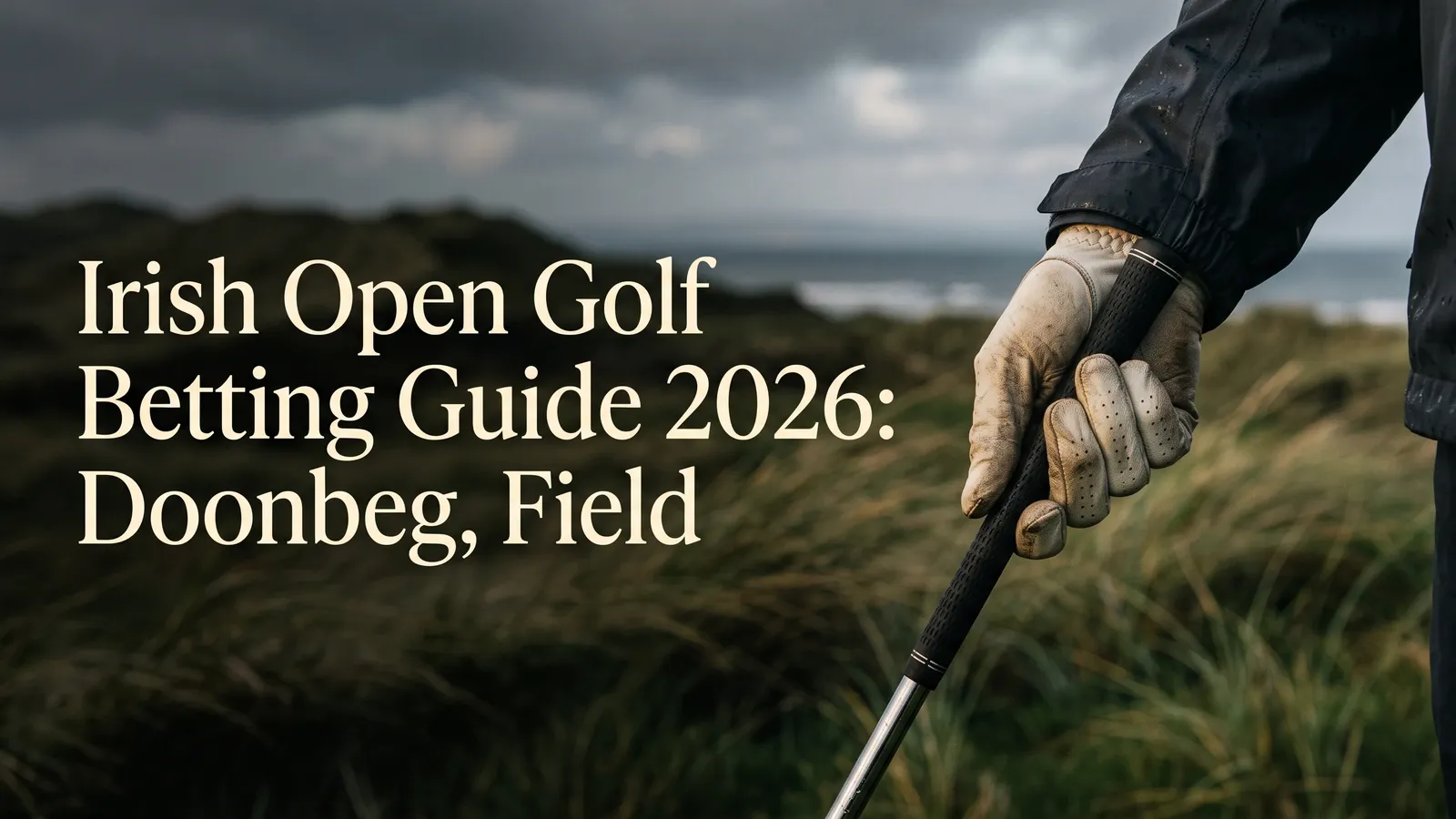 A worn beige golf glove holds a black-gripped club against blurred coastal dunes and sea beneath storm clouds, beside the Irish Open betting-guide title.